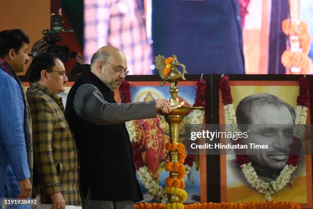 Home Minister Amit Shah, BJP working president J P Nadda and Delhi BJP president Manoj Tiwari along with others wave towards Bharatiya Janata Party's...