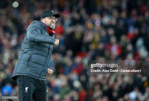 Liverpool manager Jurgen Klopp celebrates scoring the opening goal after the FA Cup Third Round match between Liverpool and Everton at Anfield on...