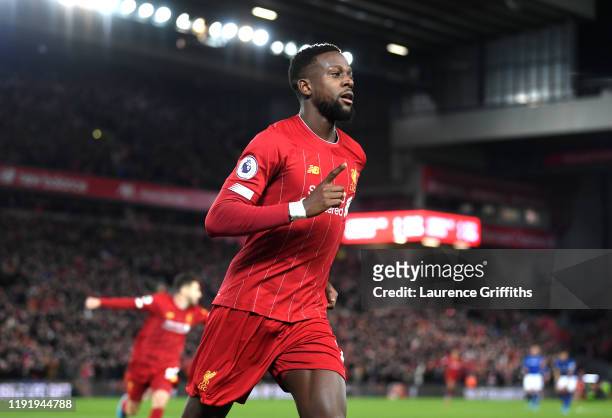 Divock Origi of Liverpool celebrates after scoring his team's first goal during the Premier League match between Liverpool FC and Everton FC at...
