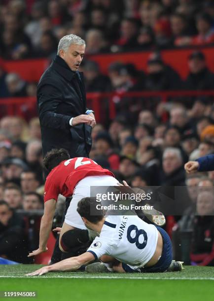 Daniel James of Manchester United collides into Jose Mourinho, Manager of Tottenham Hotspur as he is tackled by Harry Winks of Tottenham Hotspur...