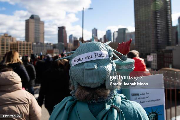 People participate in a Jewish solidarity march across the Brooklyn Bridge on January 5, 2020 in New York City. The march was held in response to a...