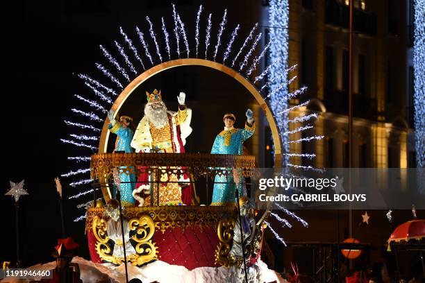 King Melchior waves to children from his float during the Three Wise Men's traditional parade on the eve of the Epiphany celebration, on January 5,...