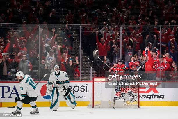 Lars Eller of the Washington Capitals celebrates with John Carlson after scoring the game winning goal in overtime against the San Jose Sharks at...