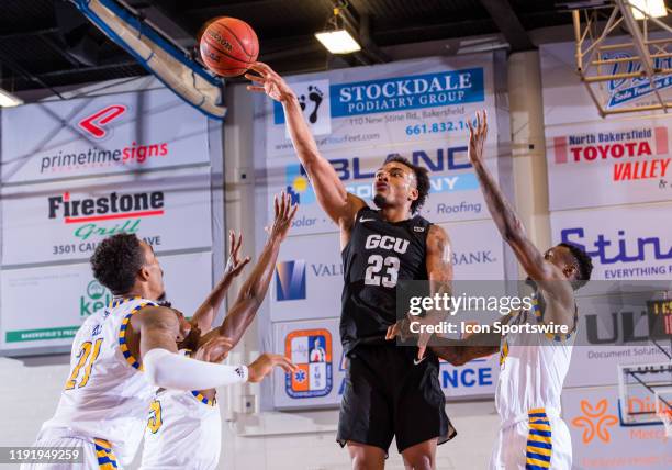 Grand Canyon guard Carlos Johnson takes a shot over Cal State Bakersfield Roadrunners forward Greg Lee during the game between the Grand Canyon and...