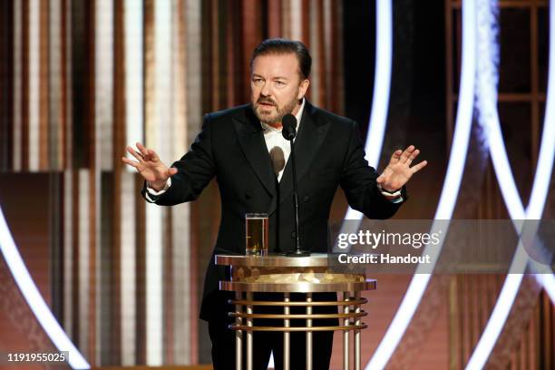 In this handout photo provided by NBCUniversal Media, LLC, host Ricky Gervais speaks onstage during the 77th Annual Golden Globe Awards at The...