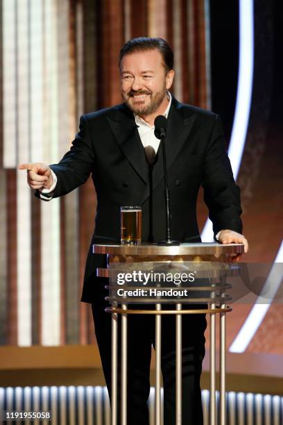 In this handout photo provided by NBCUniversal Media, LLC, host Ricky Gervais speaks onstage during the 77th Annual Golden Globe Awards at The...