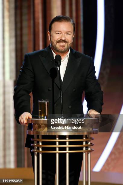 In this handout photo provided by NBCUniversal Media, LLC, host Ricky Gervais speaks onstage during the 77th Annual Golden Globe Awards at The...