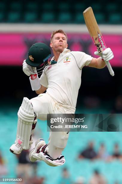 Australia's David Warner celebrates after reaching his century during the fourth day of the third cricket Test match between Australia and New...