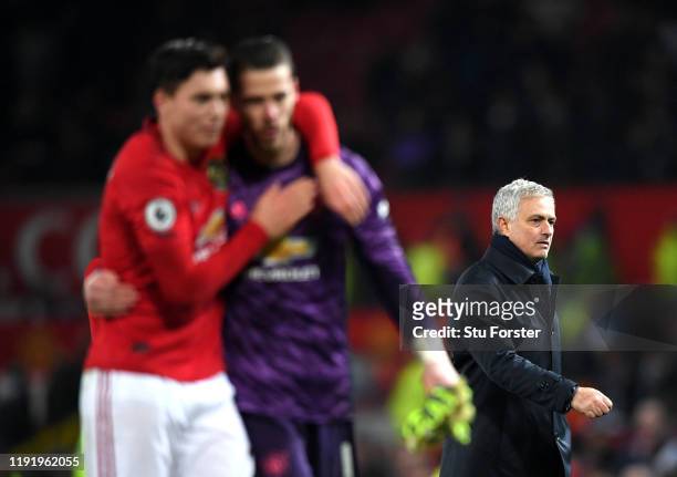 David De Gea and Victor Lindelof of Manchester United celebrate victory as Jose Mourinho, Manager of Tottenham Hotspur walks off after the Premier...