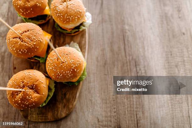 delicious slider-burgers on dining table - burger top view stock pictures, royalty-free photos & images