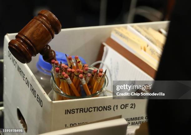 House Judiciary Committee supplies, including a gavel, are packed away at the conclusion of an impeachment hearing where constitutional scholars Noah...