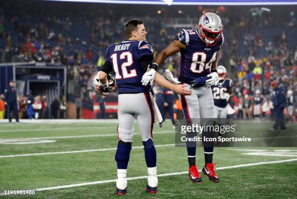 New England Patriots quarterback Tom Brady greets New England Patriots tight end Ben Watson before an AFC Wild Card game between the New England...