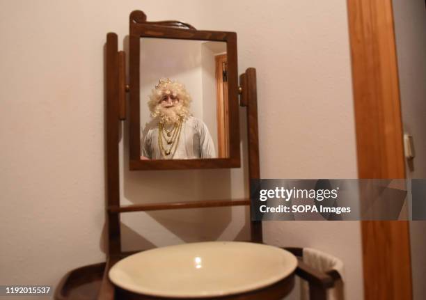Performer dressed as Melchor King is seen inside a house before the Cabalgata de Reyes or the Three Kings parade at the Spanish village of Rebollo de...