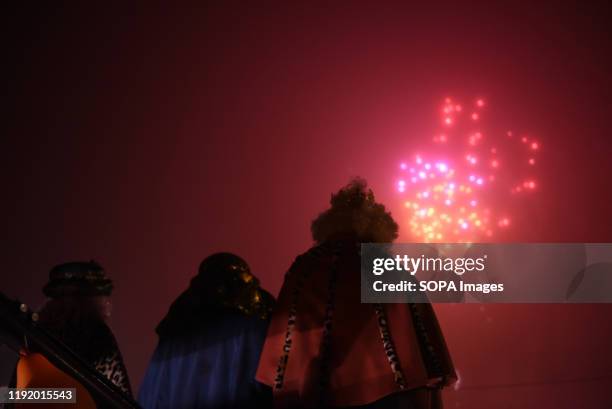 Performers dressed as Baltasar King, Gaspar King and Melchoir King watch fireworks during the Cabalgata de Reyes or the Three Kings parade at the...
