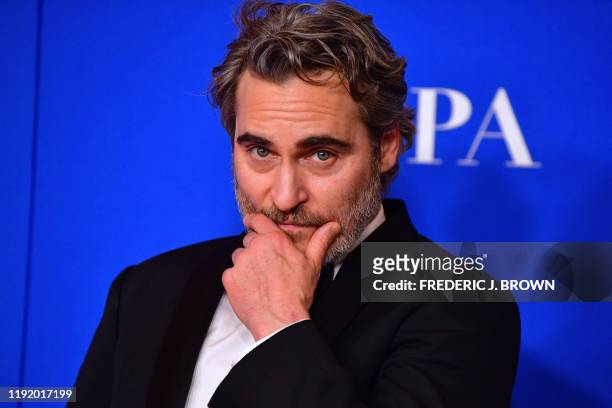 Actor Joaquin Phoenix poses in the press room after winning the award for Best Performance by an Actor in a Motion Picture - Drama during the 77th...