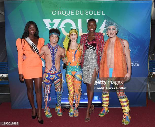 Miss Sierra Leone Marie Esther Bangura and Miss Tanzania Shubila Stanton pose with cast members of Volta during Volta By Cirque Du Soleil at Atlantic...