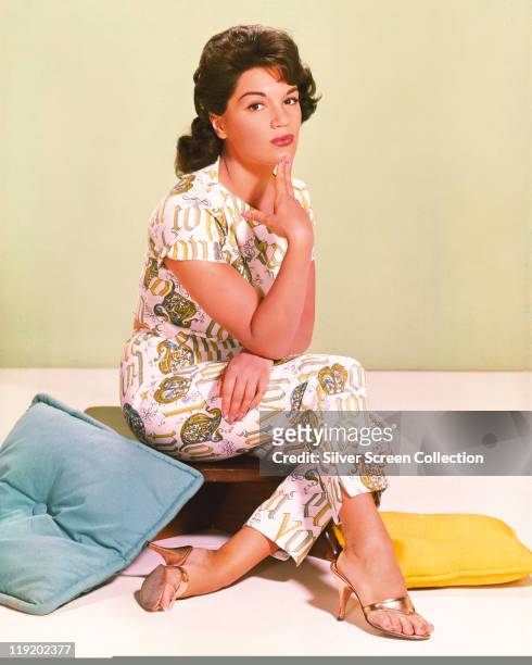 Connie Francis, US pop singer, sitting with her hand on her chin in a studio portrait, circa 1955.