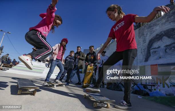 Italian activists train Young Palestinian girls to ride skateboards in Gaza City on January 6, 2020.