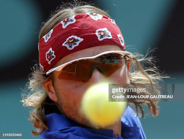 France's Arnaud Clement eyes the ball, 02 June 2003 in Paris, during his Roland Garros French Tennis Open fourth round match against Spain's Albert...