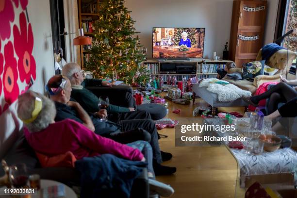 British family watch the Queen's speech to the nation on Christmas Day, a tradition started in 1932 and which she first broadcast on television in...