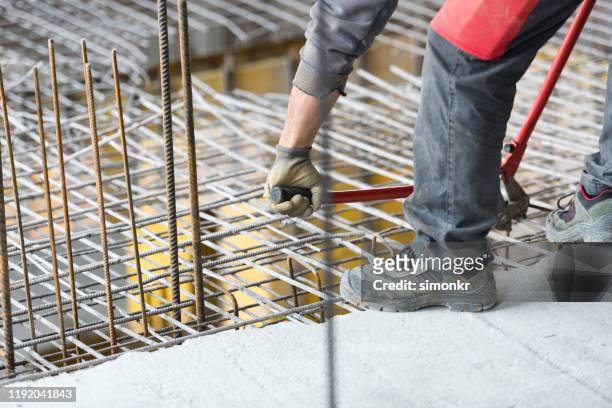construction worker cutting metal grate - bolt cutter stock pictures, royalty-free photos & images