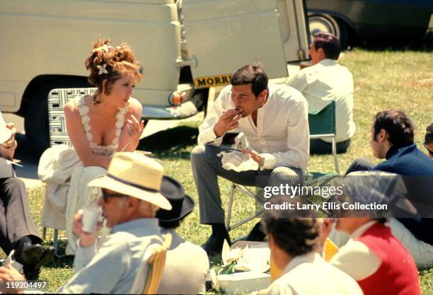 Australian actor George Lazenby and English actress Diana Rigg relax on the set of the James Bond film 'On Her Majesty's Secret Service', 1969.