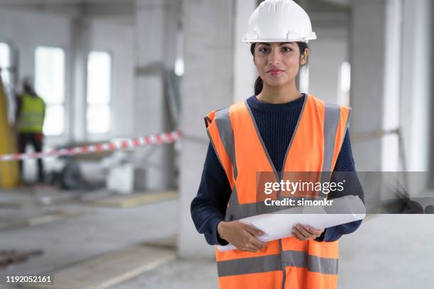 architect standing at construction site - work helmet stock pictures, royalty-free photos & images