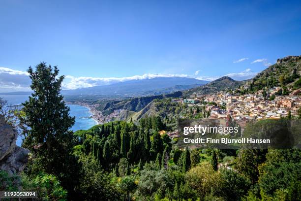 view from the ancient greek theatre in taormina sicily, giardino naxos, the mediterranian and volcano etna in the background - giardini naxos stock pictures, royalty-free photos & images