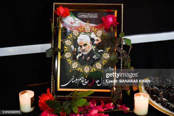 Pictures of slain Iranian military commander Qasem Soleimani is seen during a ceremony at the Iranian Consulate in Quetta on January 6, 2020. - A US...