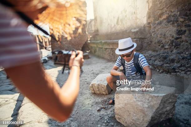 kids tourists sightseeing ruins of pompeii - pompeii stock pictures, royalty-free photos & images