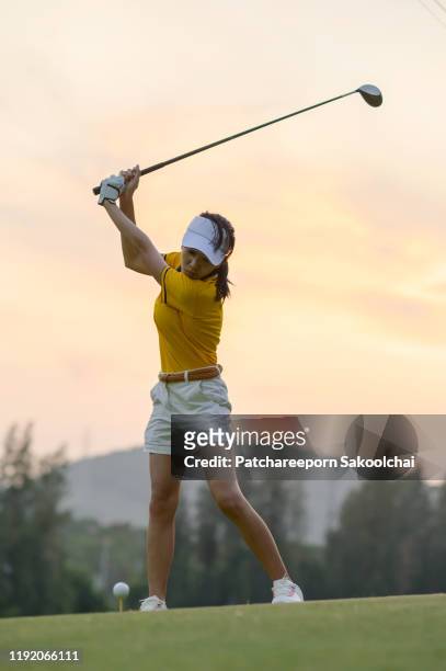 playing golf - golf swing female stock pictures, royalty-free photos & images
