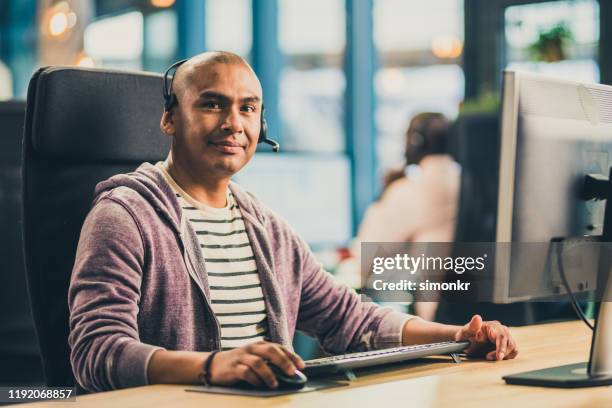 customer service representative sitting in call centre - hairless mouse stock pictures, royalty-free photos & images
