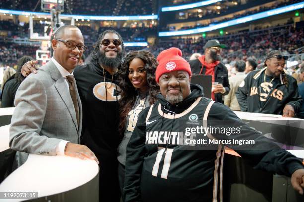 Rapper Big K.R.I.T., Shamea Morton, and DJ Wally Sparks attend the New Jersey Nets vs Atlanta Hawks halftime show at State Farm Arena on December 04,...