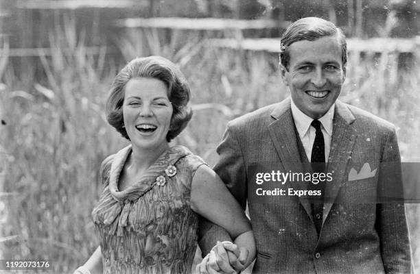 Princess Beatrix of the Netherlands holds hands with her fiance Claus van Amsberg after announcing their engagement at Soestdijk Palace in Baarn,...