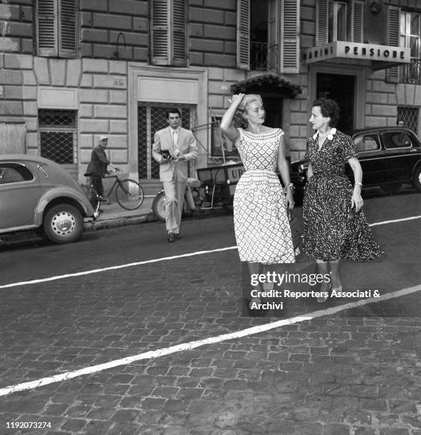 American actress Linda Christian going out after lunch with her husband Edmund Purdom and Italian stylist Micol Fontana. Rome, 27th July 1955