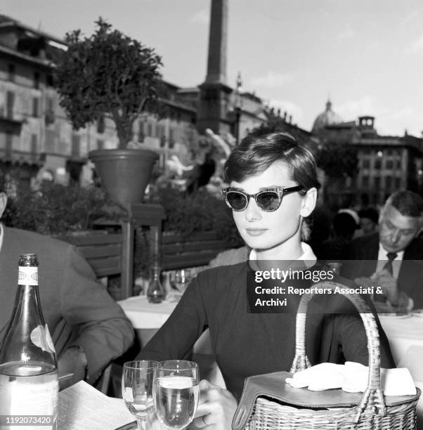 British actress Audrey Hepburn having lunch in Piazza Navona. Rome, 1959