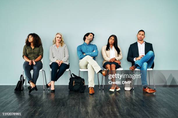 how long is this going to take? - people sitting in a row stock pictures, royalty-free photos & images