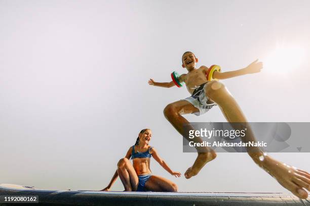 water jumping - girls swimwear stock pictures, royalty-free photos & images