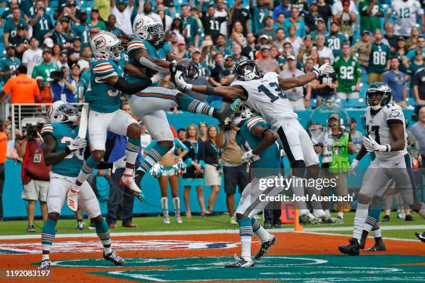 Walt Aikens of the Miami Dolphins and Nelson Agholor of the Philadelphia Eagles battle for the ball on the final play of the game on December 1, 2019...