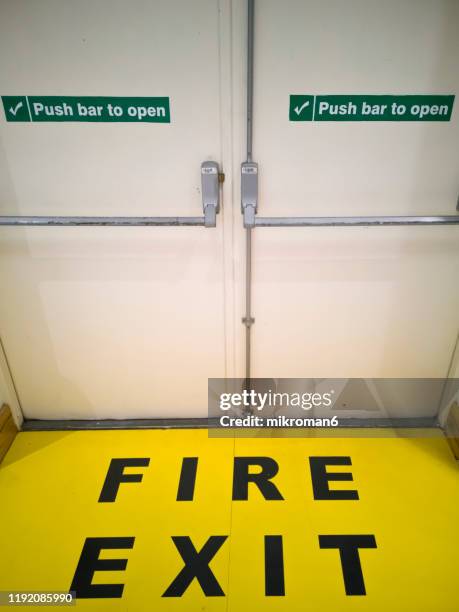 emergency fire doors in the supermarket - fire exit sign stock pictures, royalty-free photos & images