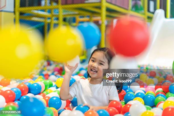 cute girl at the ball pool - ball pit stock pictures, royalty-free photos & images