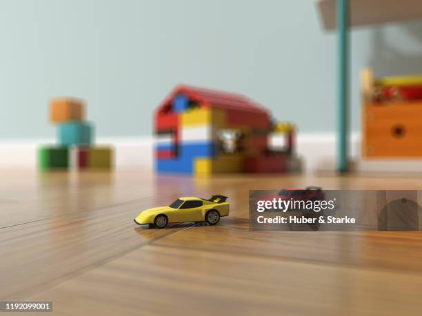toy cars on parquet floor in playroom - playroom stock-fotos und bilder