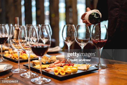 Sommelier serving glasses of winetasting event Sommelier serving glasses of winetasting event