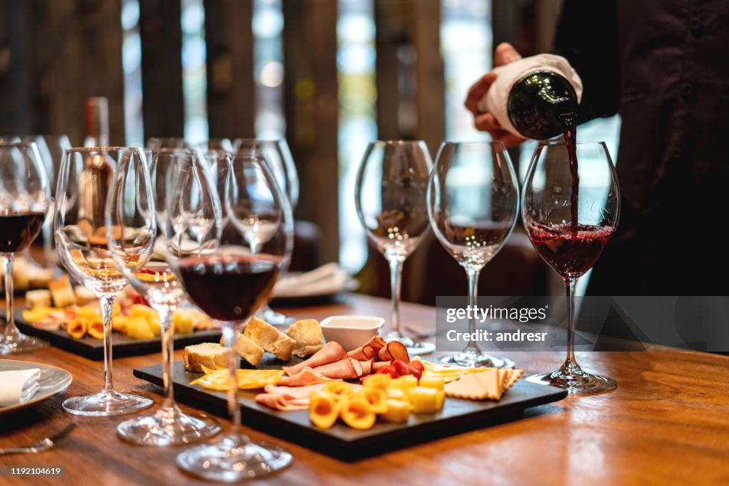 Sommelier serving glasses of winetasting event