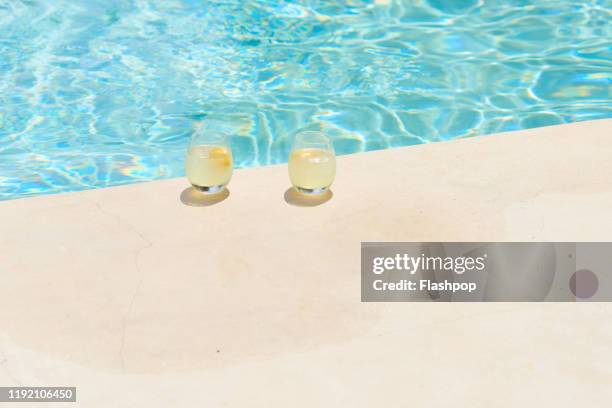 two refreshing drinks sat poolside - bassängkant bildbanksfoton och bilder