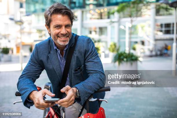 pedalling on through a city - portrait man building stock pictures, royalty-free photos & images