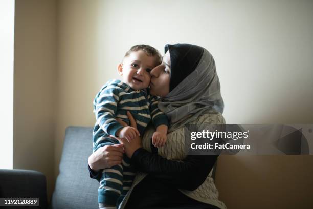 muslim mother and son stock photo - refugee babies stock pictures, royalty-free photos & images