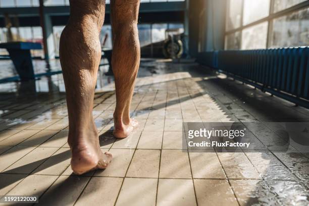 senior man walking near swimming pool - mens bare feet stock pictures, royalty-free photos & images