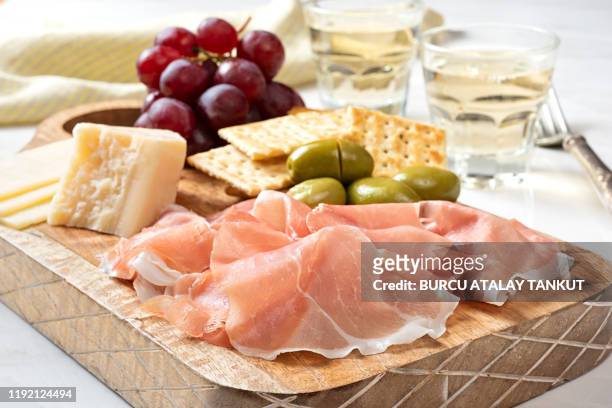 antipasto platter with white wine - prosciutto stock pictures, royalty-free photos & images