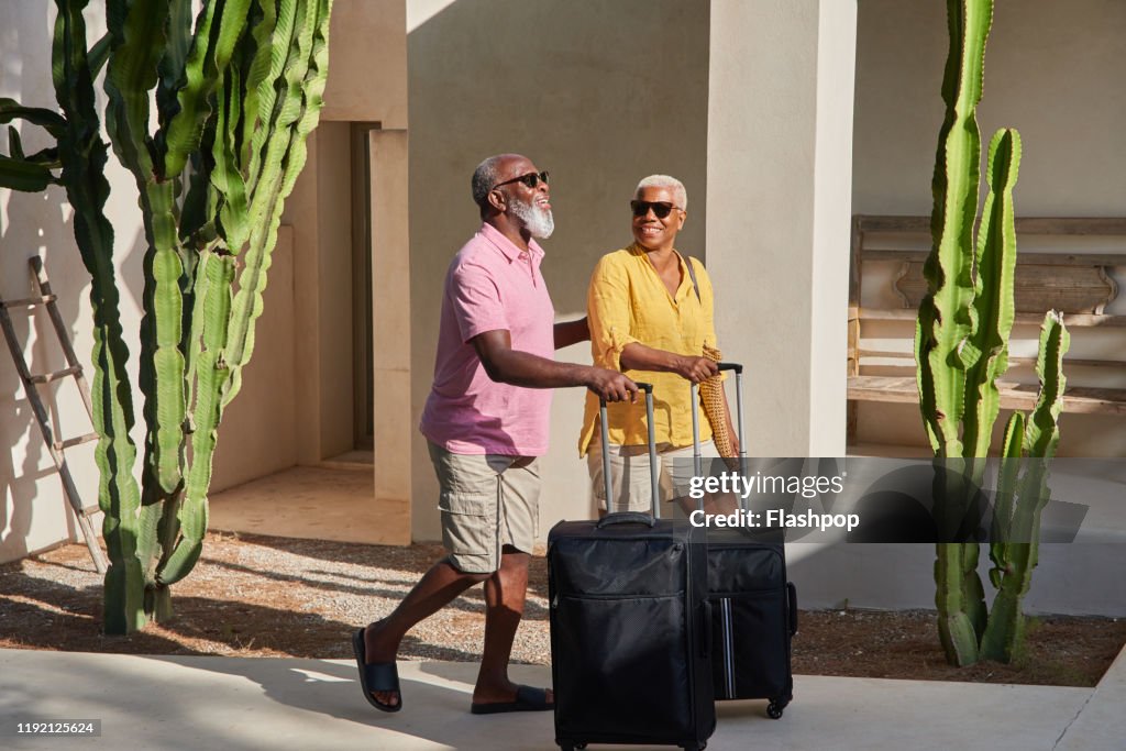 A mature couple arrive at a holiday villa
